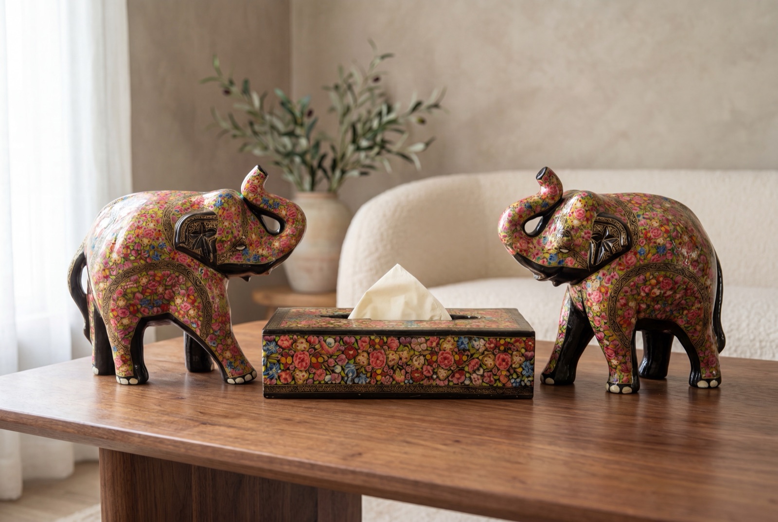 Hand-painted elephants and tissue box on a sideboard