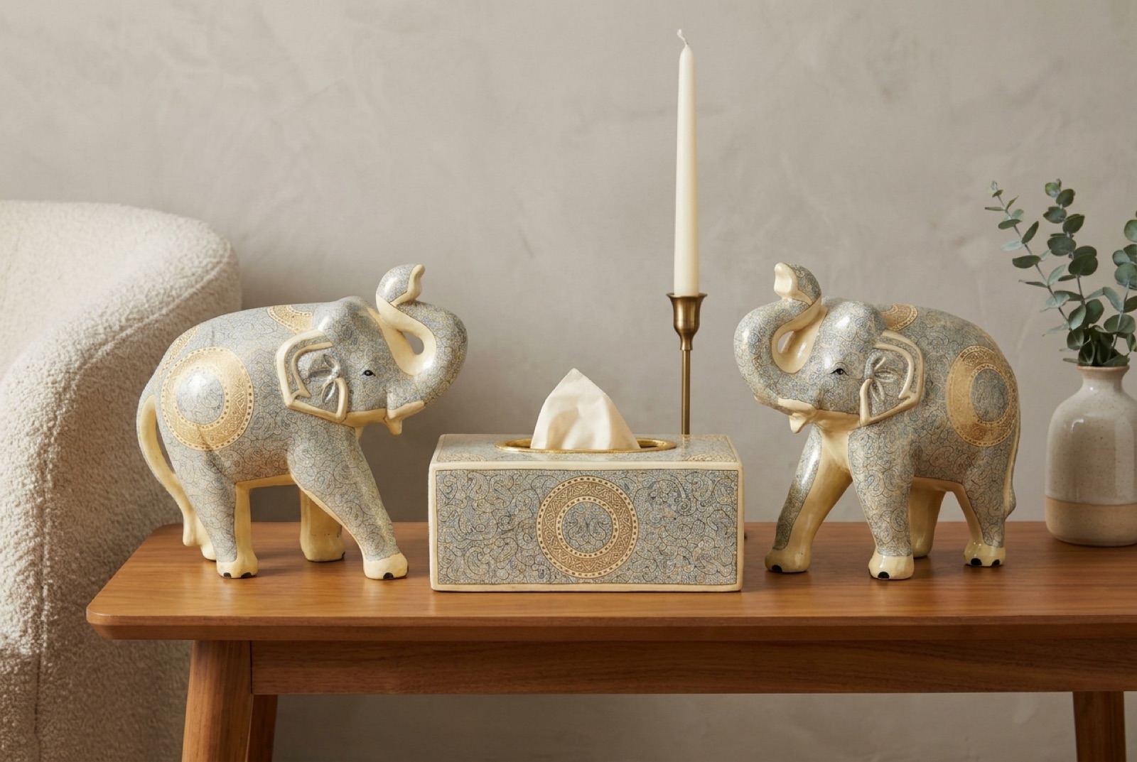 Ivory hand-painted elephants beside a tissue box